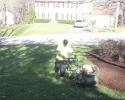 Professional landscaper aerating a lawn to provide proper root space and water and nutrient absorption.